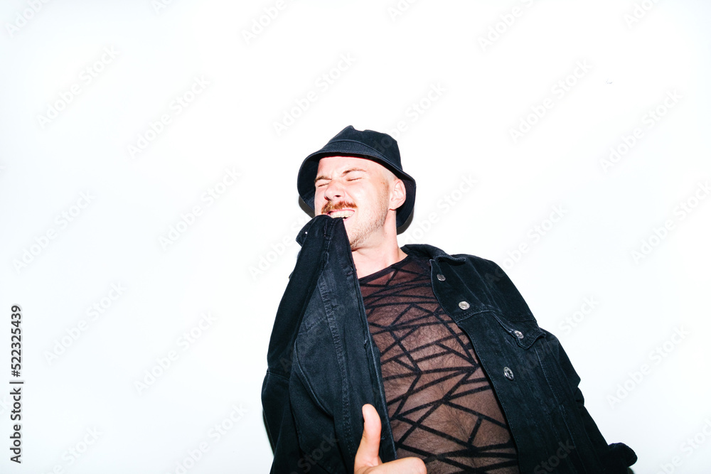 Portrait of androgynous model On Isolate Background Biting His Jacket Portrait of androgynous model On Isolate Background Biting His Jacket
