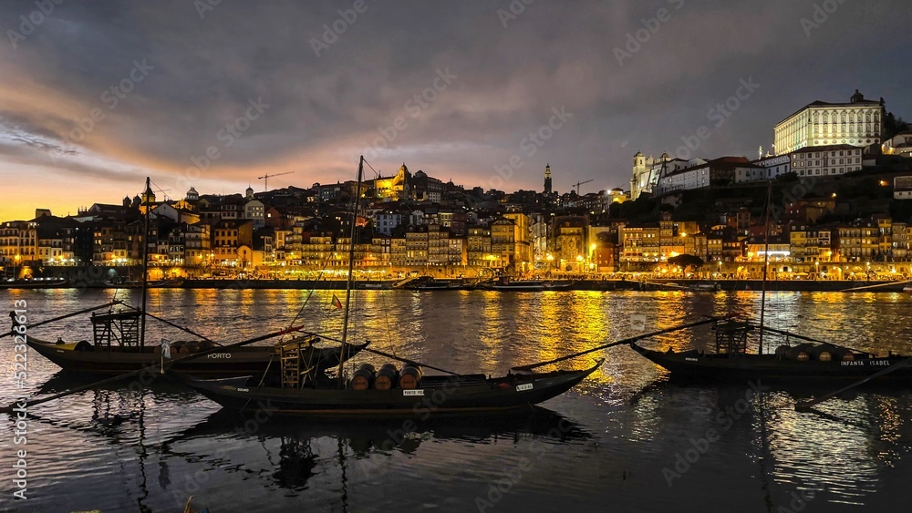Porto,Portugal: July 6,,2022- Panoramic view of night skyline of Old Porto town shot from the banks of river Douro in Porto, Portugal