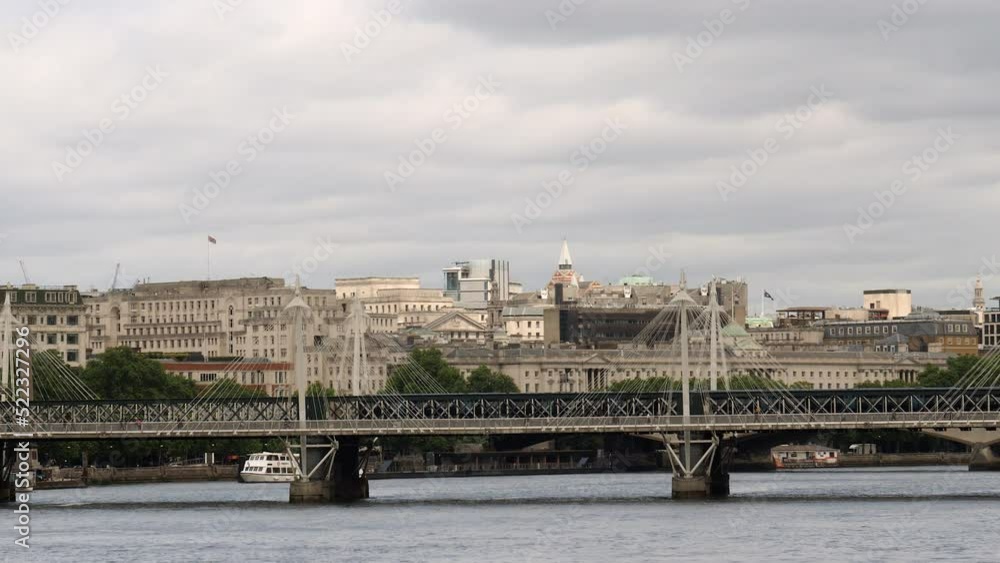 Train crossing Hungerford Bridge over Thames river in London, United Kingdom. Train crossing Hungerford Bridge over Thames river in London, United Kingdom.