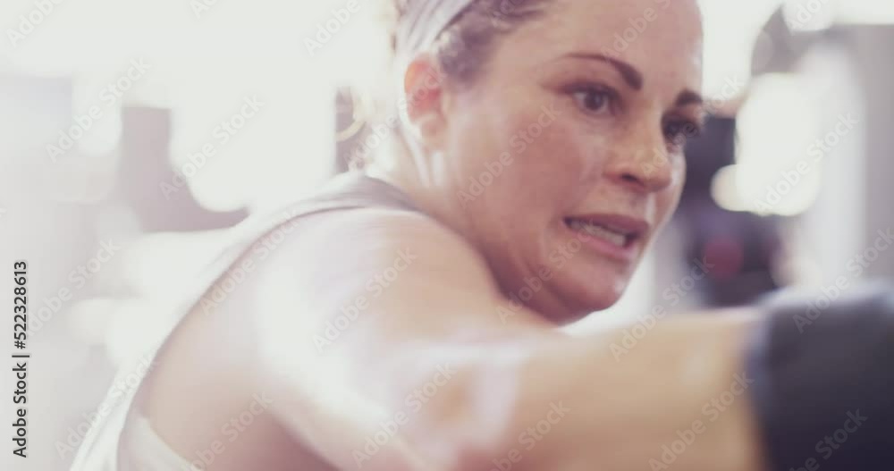 Fit, active and healthy woman boxing and hitting a punching back in a routine workout, training or gym exercise in a wellness center. Sporty, strong or plus size boxer in combat sports to lose weight Fit, active and healthy woman boxing and hitting a punching back in a routine workout, training or gym exercise in a wellness center. Sporty, strong or plus size boxer in combat sports to lose weight