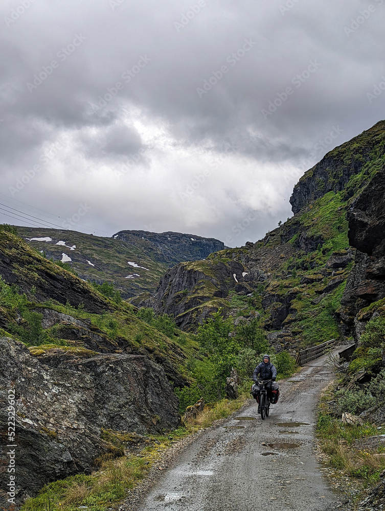 A tourist man biking on the famous Rallarvegen norwegian trip road 2