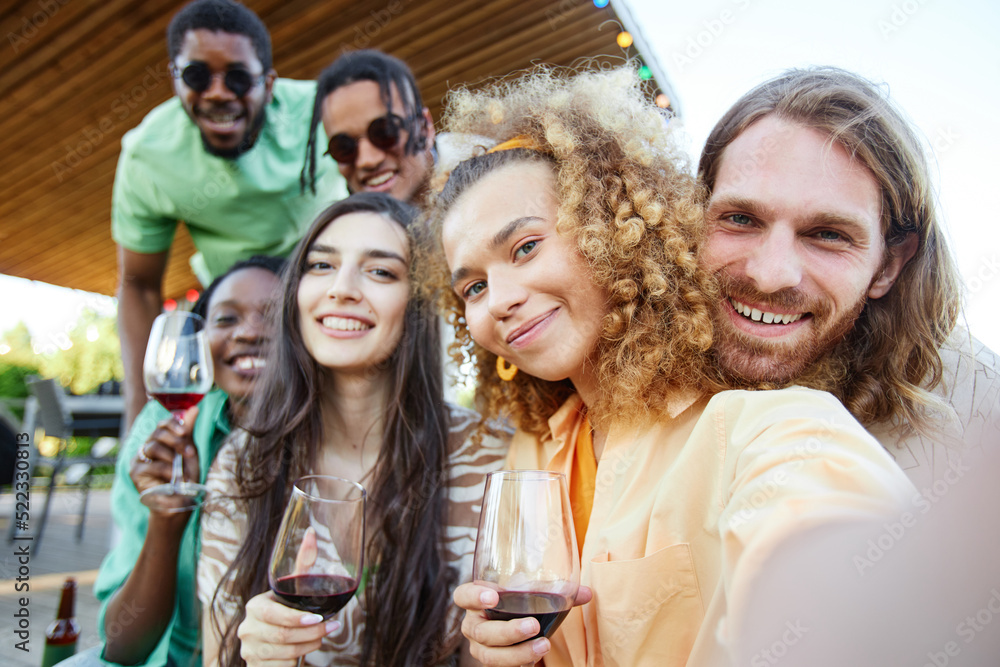 POV shot of friends taking selfie photo during outdoor party in Summer all smiling at camera POV shot of friends taking selfie photo during outdoor party in Summer all smiling at camera