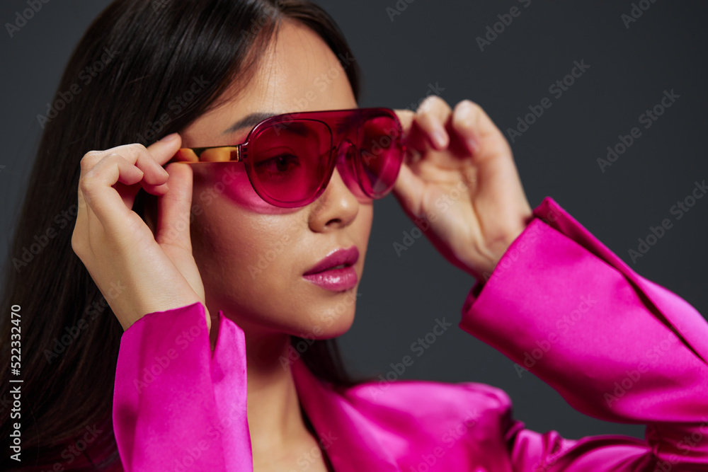 young woman in a pink mini dress fashion glasses luxury isolated background young woman in a pink mini dress fashion glasses luxury isolated background
