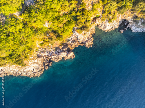 Rocky cliffs and blue sea on sunny summer day