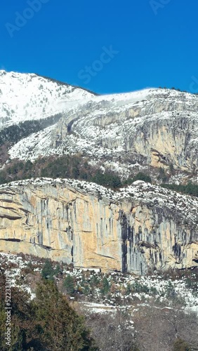 Vertical Timelapse of a snowy mountain in the Pyrenees on a sunny and windy day