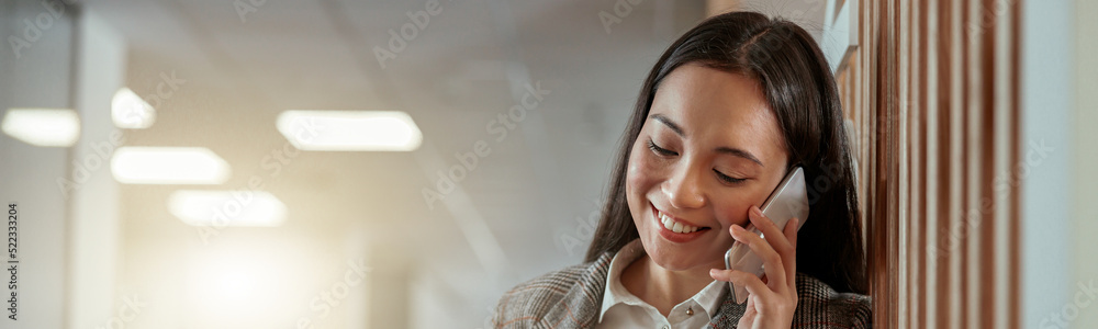 Asian business woman talking phone with client and smile. Blurred background Asian business woman talking phone with client and smile. Blurred background