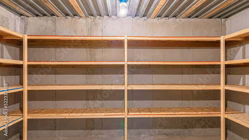 Panorama Unfinished food storage at the basement with concrete walls
