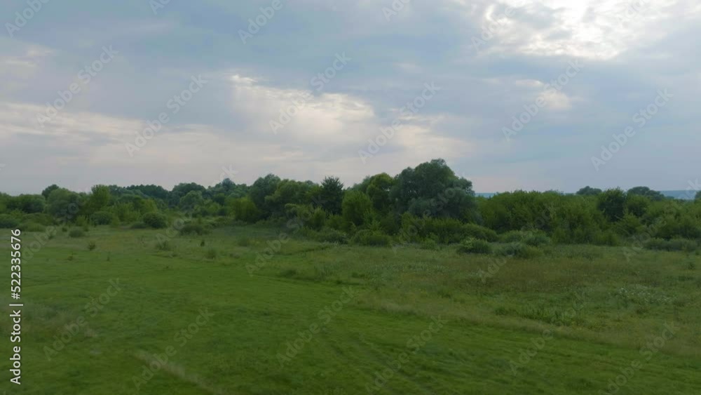 Flight over green fields and trees against the sky. Landscape. Clouds. Nature. Drone video 4k footage Flight over green fields and trees against the sky. Landscape. Clouds. Nature. Drone video 4k footage