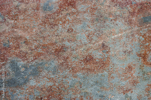 Old cracked painted textured brown background with blue spots.