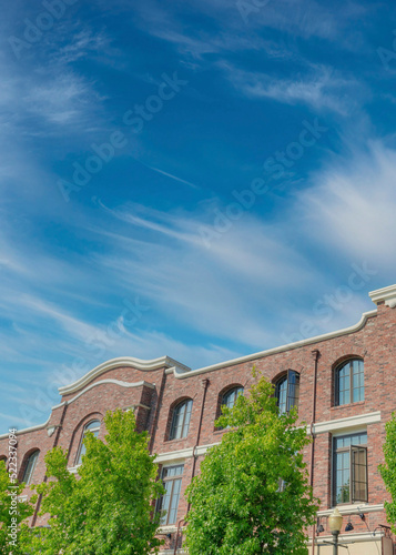 Vertical Whispy white clouds Industrial buildings with bricks in a low angle view at San Marc