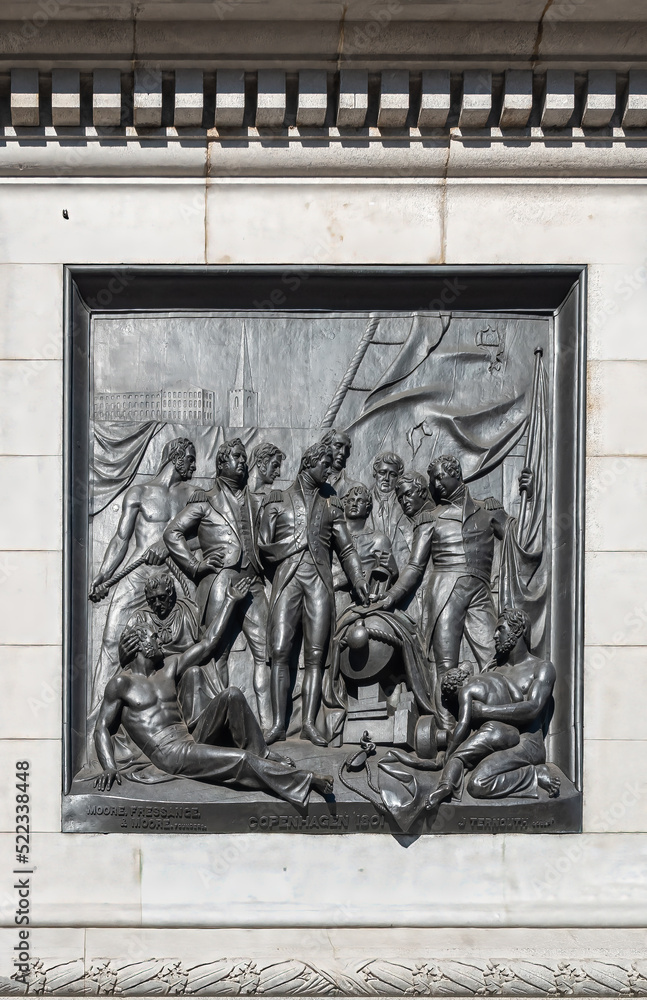 London, UK- July 4, 2022: Trafalgar Square. Closeup of black mural sculpture set in white marble pedestal of Nelson's Column depicts scene of naval battle at Copenhagen in 1801