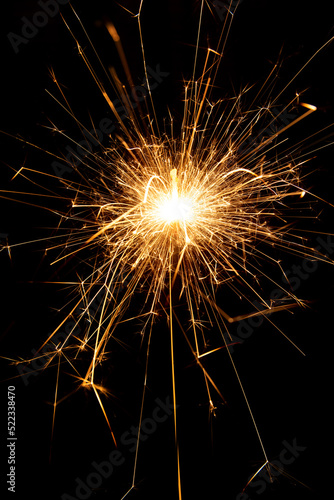 Sparkler candle used in celebrations  black background  selective focus.