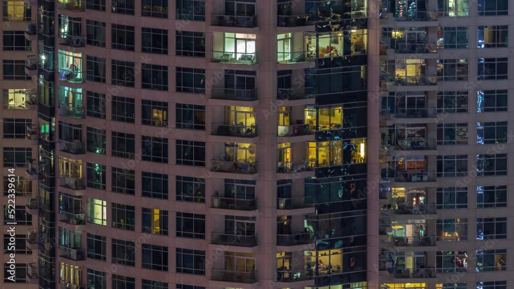 Evening view of exterior apartment recidential building timelapse with many glowing windows. High rise illuminated skyscraper with lights Evening view of exterior apartment recidential building timelapse with many glowing windows. High rise illuminated skyscraper with lights