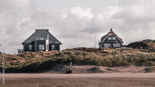 Beach houses in Fanø Island under the cloudy sky