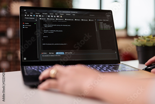 App developer using terminal window with code, developing new user interface on programming html software. Coding firewall security with online cloud app on laptop, IT development. Close up.