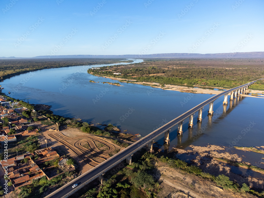 Beautiful bridge over the silver river in the morning sun on the edge of a small town in the interior of northeastern Brazil, Rio São Francisco