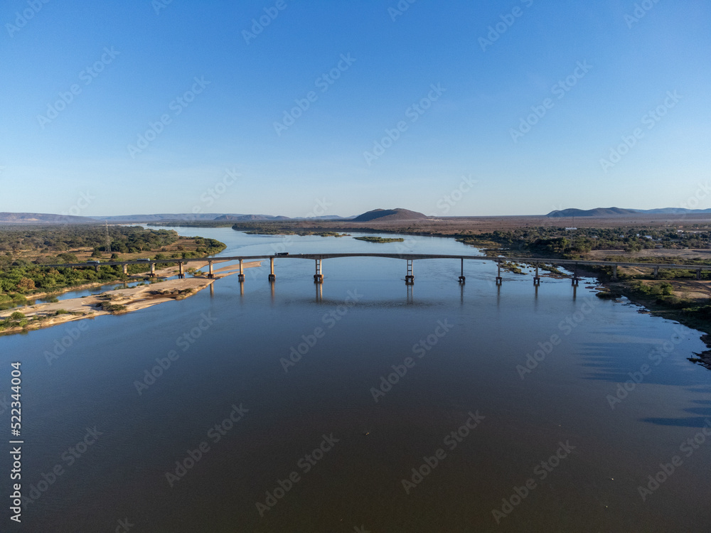 Beautiful bridge over the silver river in the morning sun on the edge of a small town in the interior of northeastern Brazil, Rio São Francisco