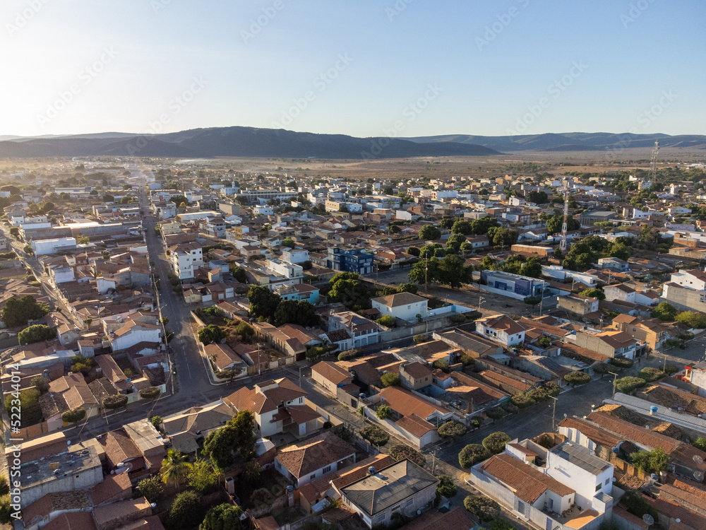 Small town with low houses lit by the rising sun in the countryside of Brazil