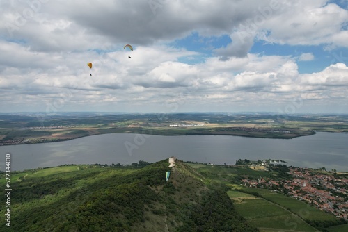 paragliding beauty of free flight, scenic panorama mountains,Palava,Pavlovske vrchy,Czech republic,Europe,scenic aerial panorama landscape view,paraglider wings	
 photo