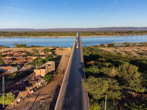 Beautiful bridge over the silver river in the morning sun on the edge of a small town in the interior of northeastern Brazil, Rio São Francisco photo