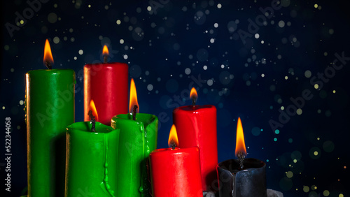 Happy kwanzaa concept with black, red and green candles on dark background, selective focus photo
