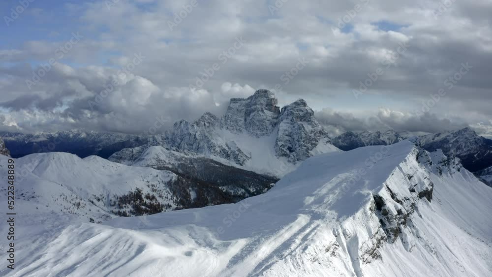 Aerial Forward Shot Of Snow Covered Rock Formations Under Cloudy Sky - Giau Pass, Italy Aerial Forward Shot Of Snow Covered Rock Formations Under Cloudy Sky - Giau Pass, Italy