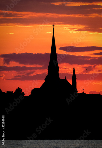 Gorgeous steeple silhouetted sunset. © Lisa