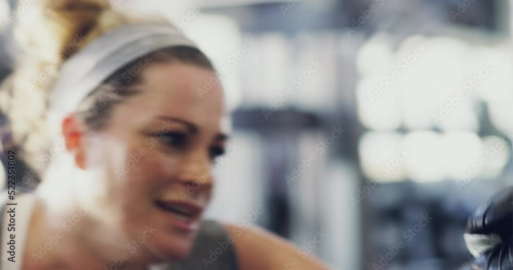 Active and fit woman hitting a punching bag at the gym training to lose
