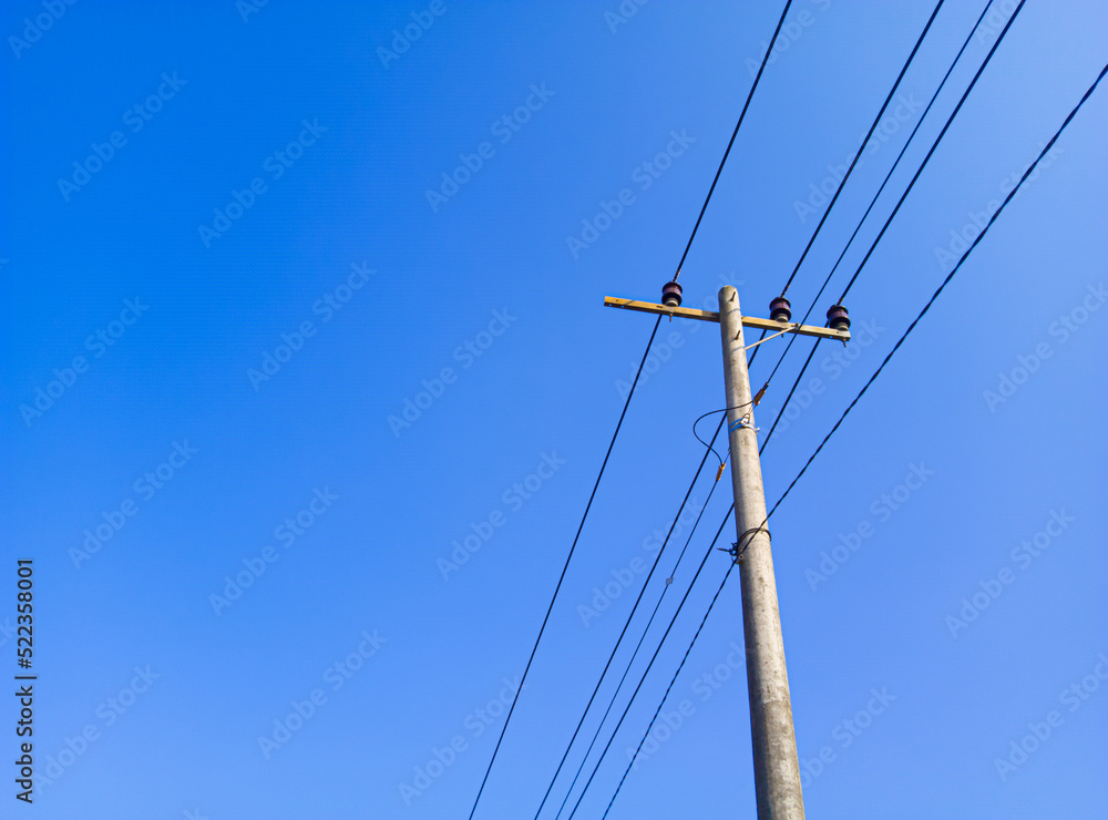 electric pole in a minimalist composition on a bright blue sky with empty space to enter text electric pole in a minimalist composition on a bright blue sky with empty space to enter text