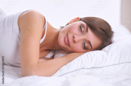 Beautiful girl sleeps in the bedroom, lying on bed