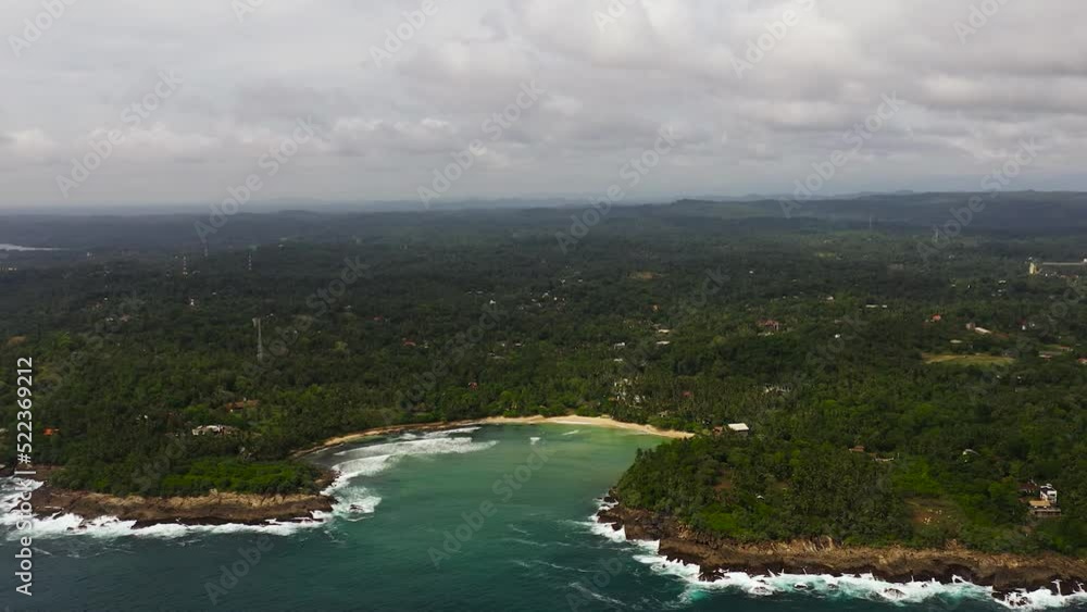 Aerial view of bay with a Hiriketiya beach among palm trees. Surf spot in Sri Lanka. Aerial view of bay with a Hiriketiya beach among palm trees. Surf spot in Sri Lanka.