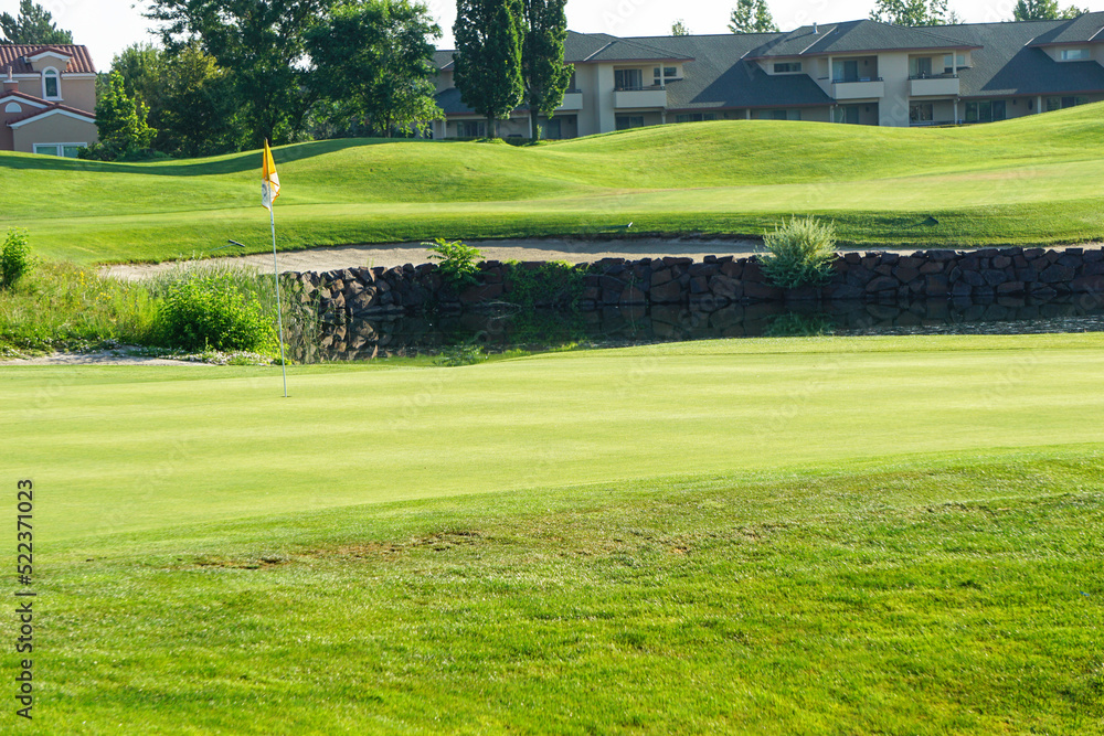 Golf pin flag on golf course green