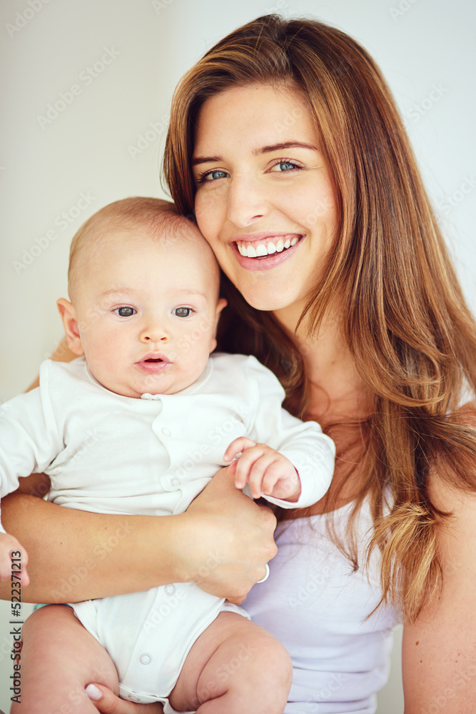 A beautiful, loving and caring mother holding baby, smiling and looking happy with new born. Single blonde parent or young mom showing love and care for her infant, bonding and smiling together A beautiful, loving and caring mother holding baby, smiling and looking happy with new born. Single blonde parent or young mom showing love and care for her infant, bonding and smiling together
