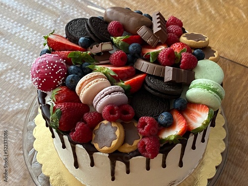 Big cake with berries and chocolate