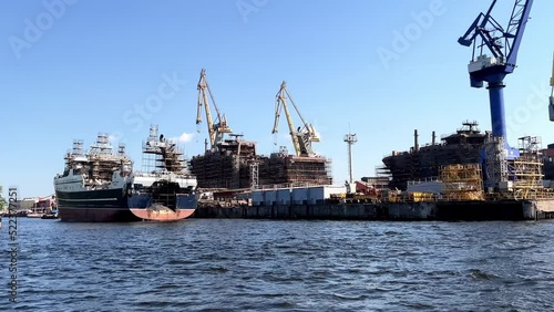 Wallpaper Mural View from sea, offshore shipyards large commercial ships under construction, cranes, dry dock, offshore platform, blue green sea, blue sky with cloud.Engineering and mechanical engineering concept Torontodigital.ca