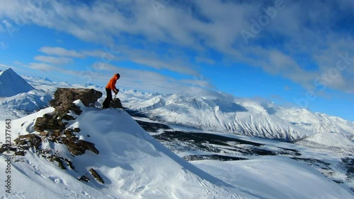 Male Tourist Skiing On Snow Covered Rock Formation During Vacation -  Fairbanks, Alaska photo