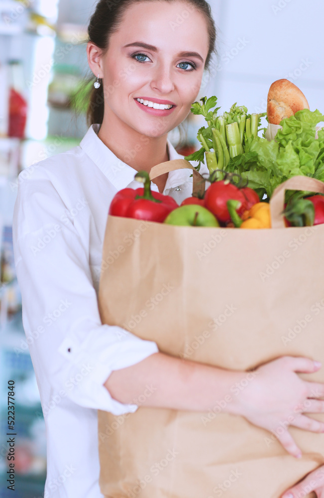 Smiling woman online shopping using tablet and credit card in kitchen Smiling woman online shopping using tablet and credit card in kitchen