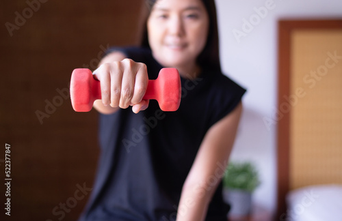 Woman exercise with lifting dumbbell at home,Personal workout,Routine plans exercises