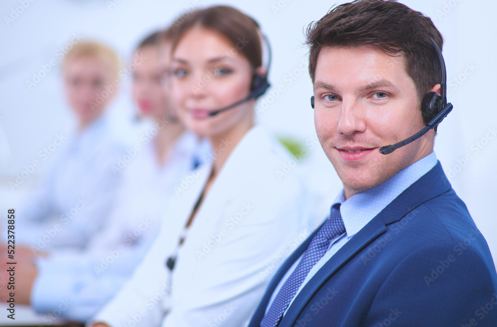 Attractive positive young businesspeople and colleagues in a call center office Attractive positive young businesspeople and colleagues in a call center office