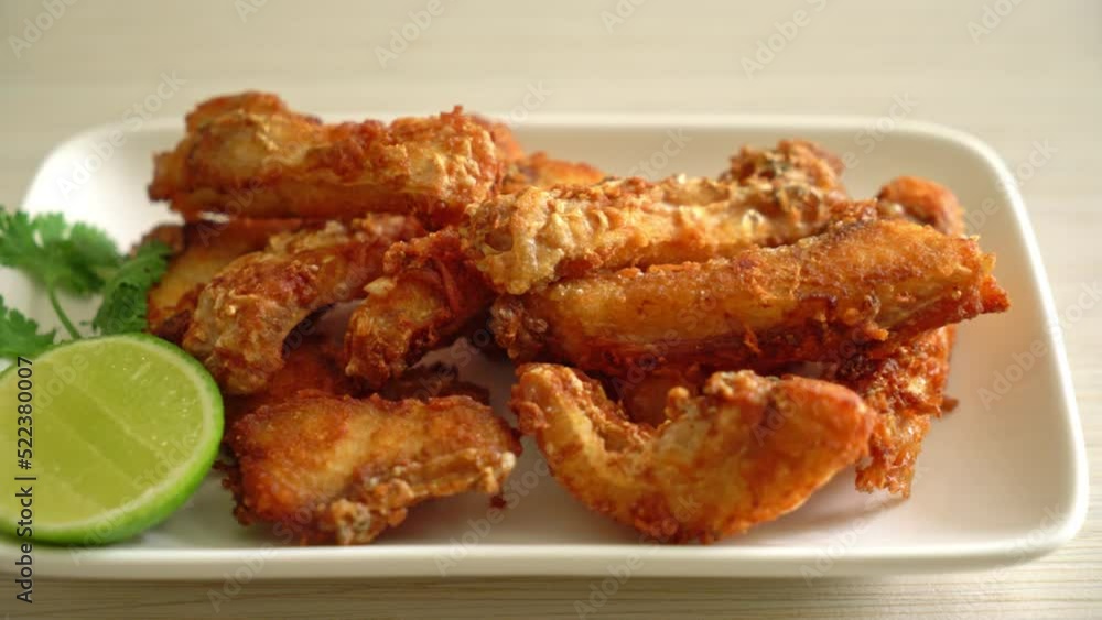 Fried Snapper Belly on white plate - Asian food style Fried Snapper Belly on white plate - Asian food style
