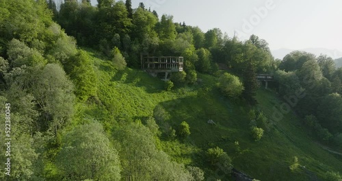 Old And Abandoned Structures On Dense Forest Mountains Of Bakuriani In Georgia. Aerial Shot photo