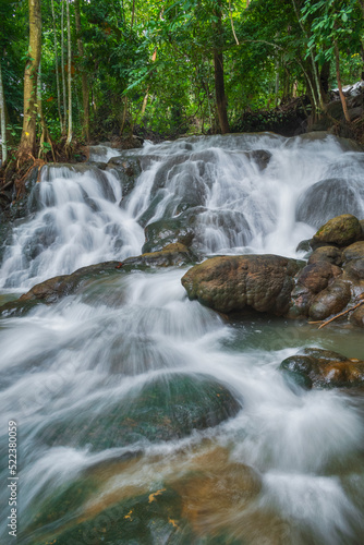 slow shutter speed of white silky water stream waterfall. one of tourism object located in Malili, east Luwu named Tompotikka waterfall photo