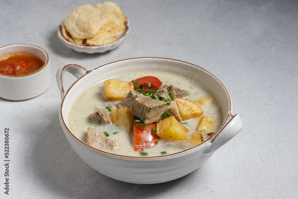Soto Betawi. Traditional beef and offal soup from Betawi, Jakarta. The soup has been preplated in a bowl; ready to be served. Soto Betawi. Traditional beef and offal soup from Betawi, Jakarta. The soup has been preplated in a bowl; ready to be served.