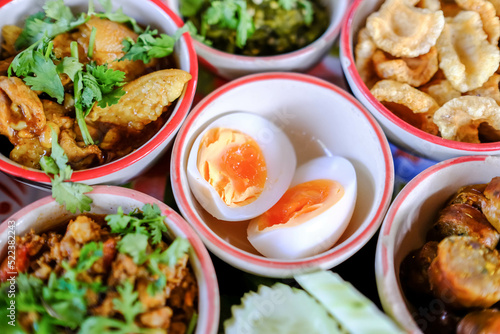 Northern traditional thai food set called "Kantoke Dinner" consist of crispy pork,tomato paste, mix vegetable,mince pork, chilli paste, sausage