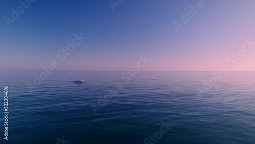 Aerial view of Mediterranean sea during dusk hours with boat in the horizon photo