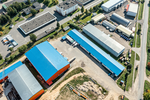 aerial view of goods warehouses. logistics center in suburb industrial area. drone point view. © Mr Twister