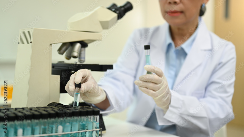 Researchers scientist working with blue liquid test tube in the laboratory. Medicine and science researching concept Researchers scientist working with blue liquid test tube in the laboratory. Medicine and science researching concept