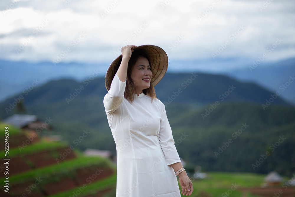 Asian beautiful woman with terraced green rice fields at Ban pa pong piang rice terraces of Chiang Mai, Thailand