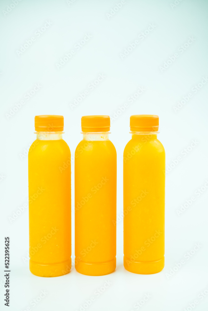 Three bottles of delicious orange juice Three bottles of delicious orange juice