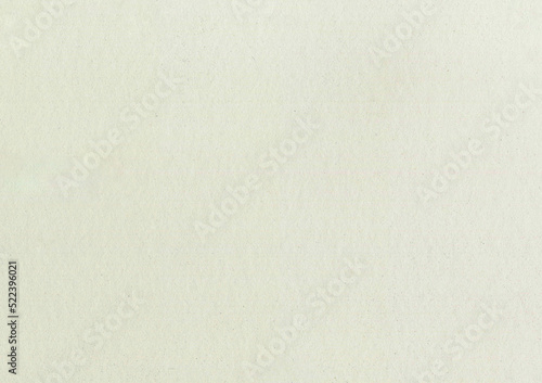 High resolution large image old yellowed weathered beige grainy paper texture background scan with fine grain fiber and dust particles with copy space for text used for wallpapers